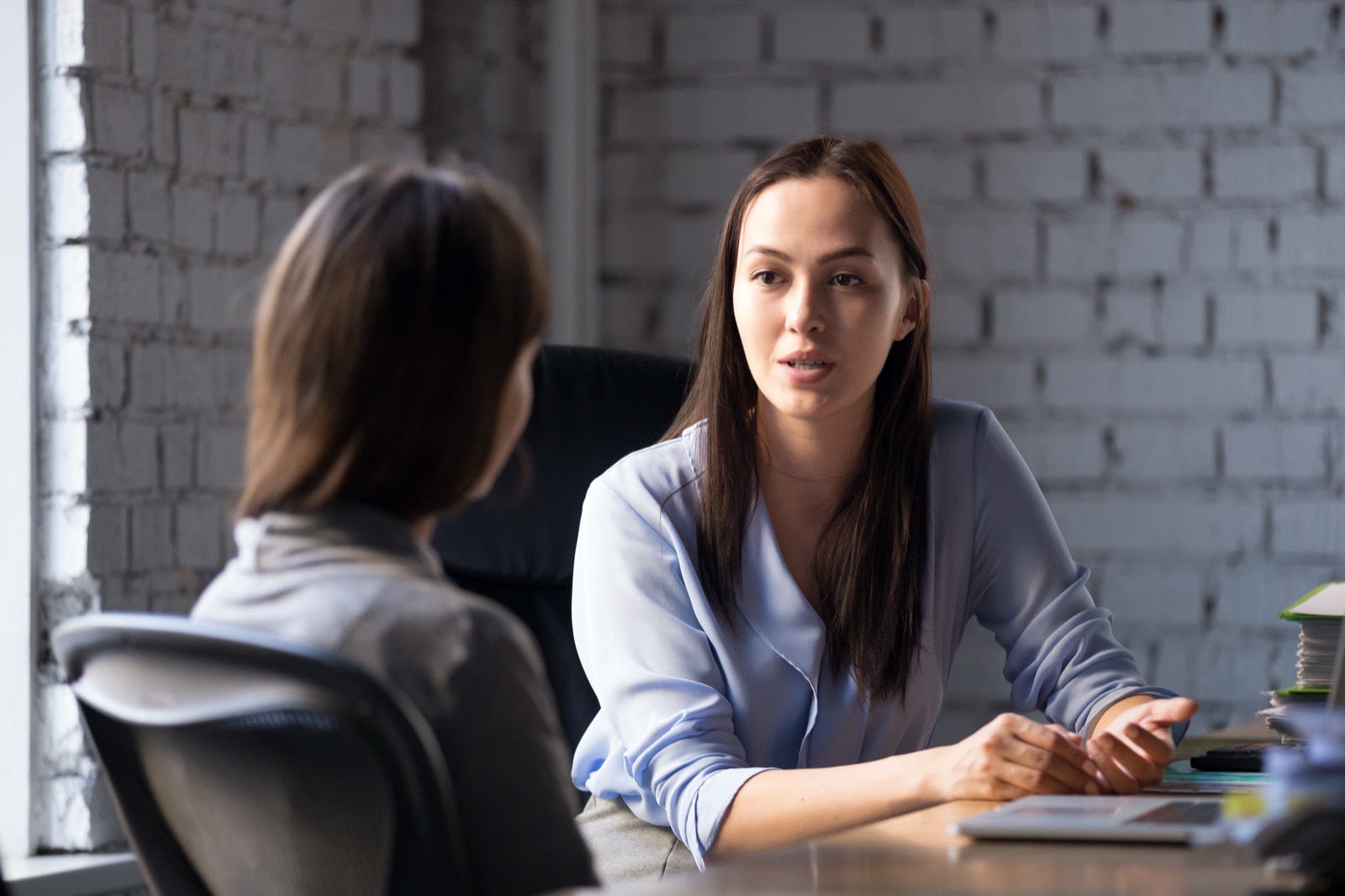 A one-to-one resilience and stress-management coaching conversation in an office