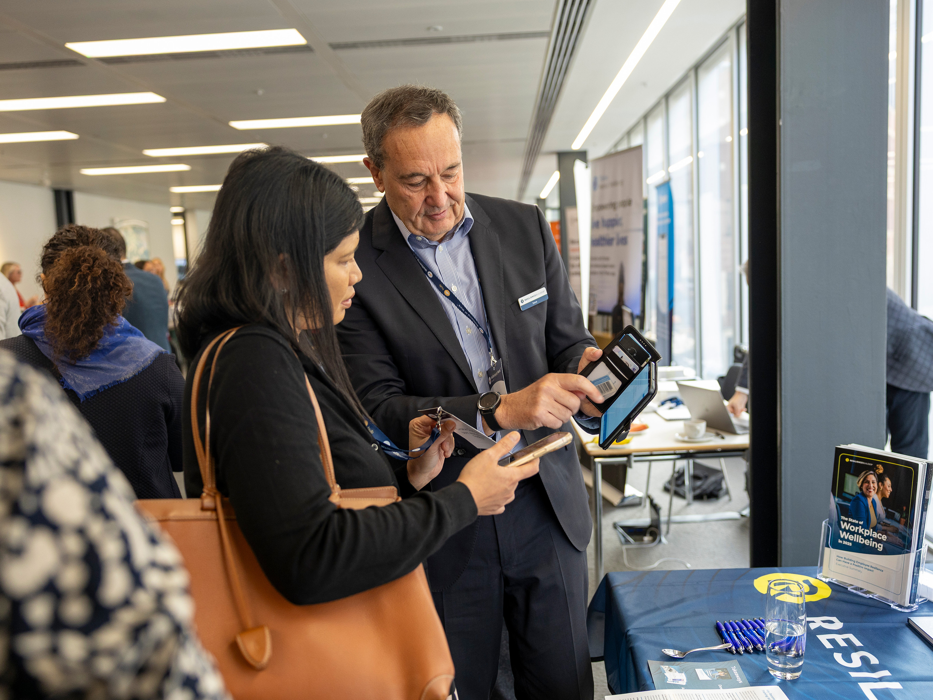 Steve Howe in conversation with a delegate at a Wellbeing at Work event